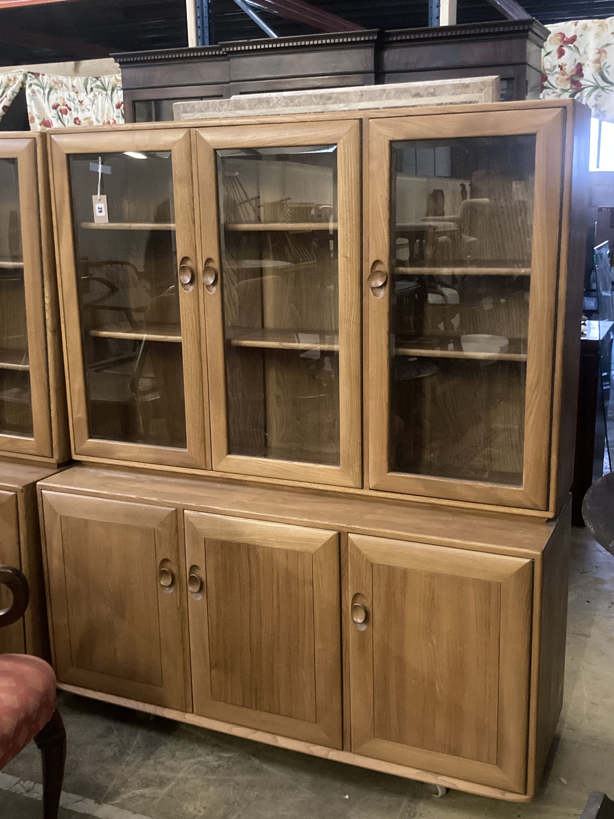 An Ercol display cabinet fitted three glazed panelled doors over cupboards, width 136cm depth 44cm height 162cm
